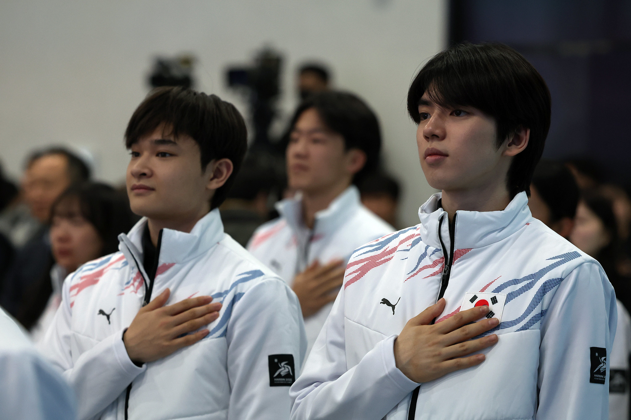 Figure skaters Cha Jun-hwan (right) and Kim Hyun-gyeom pledge allegiance to the national flag in the Songpa-gu District of the capital, during a launch ceremony for the national team competing in the 2025 Asian Winter Games to be held in Harbin, China.  .